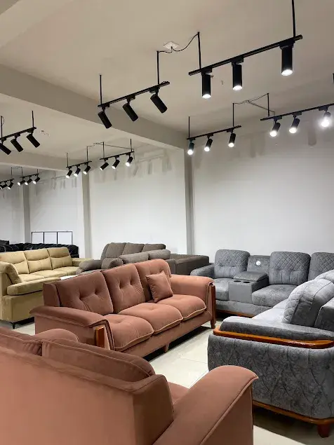 Happy woman sitting on modern furniture in a stylish living room